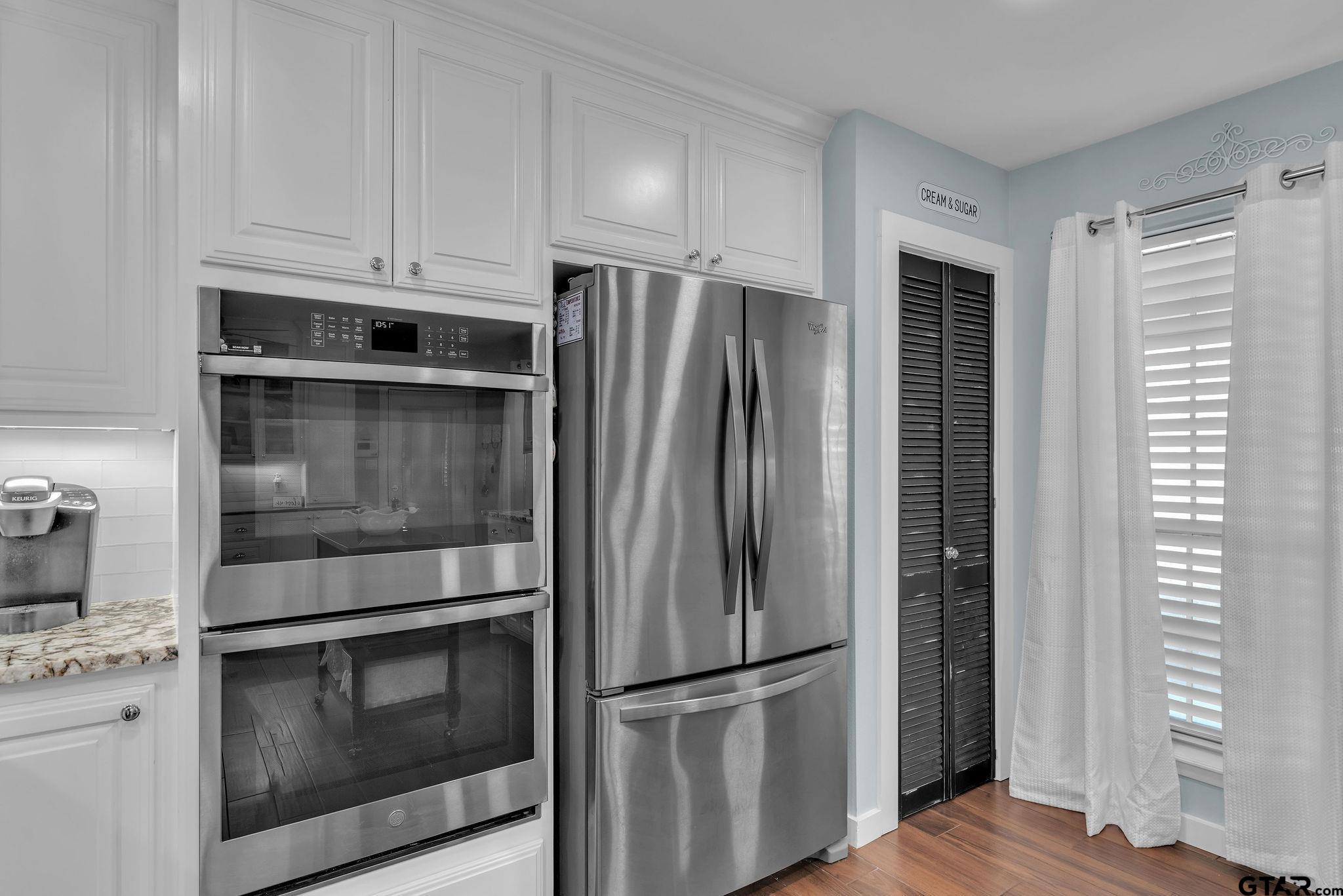 1208 Briarwood Lane Longview, TX 75604 - Photo 16 of 43 a metallic refrigerator freezer sitting inside of a kitchen