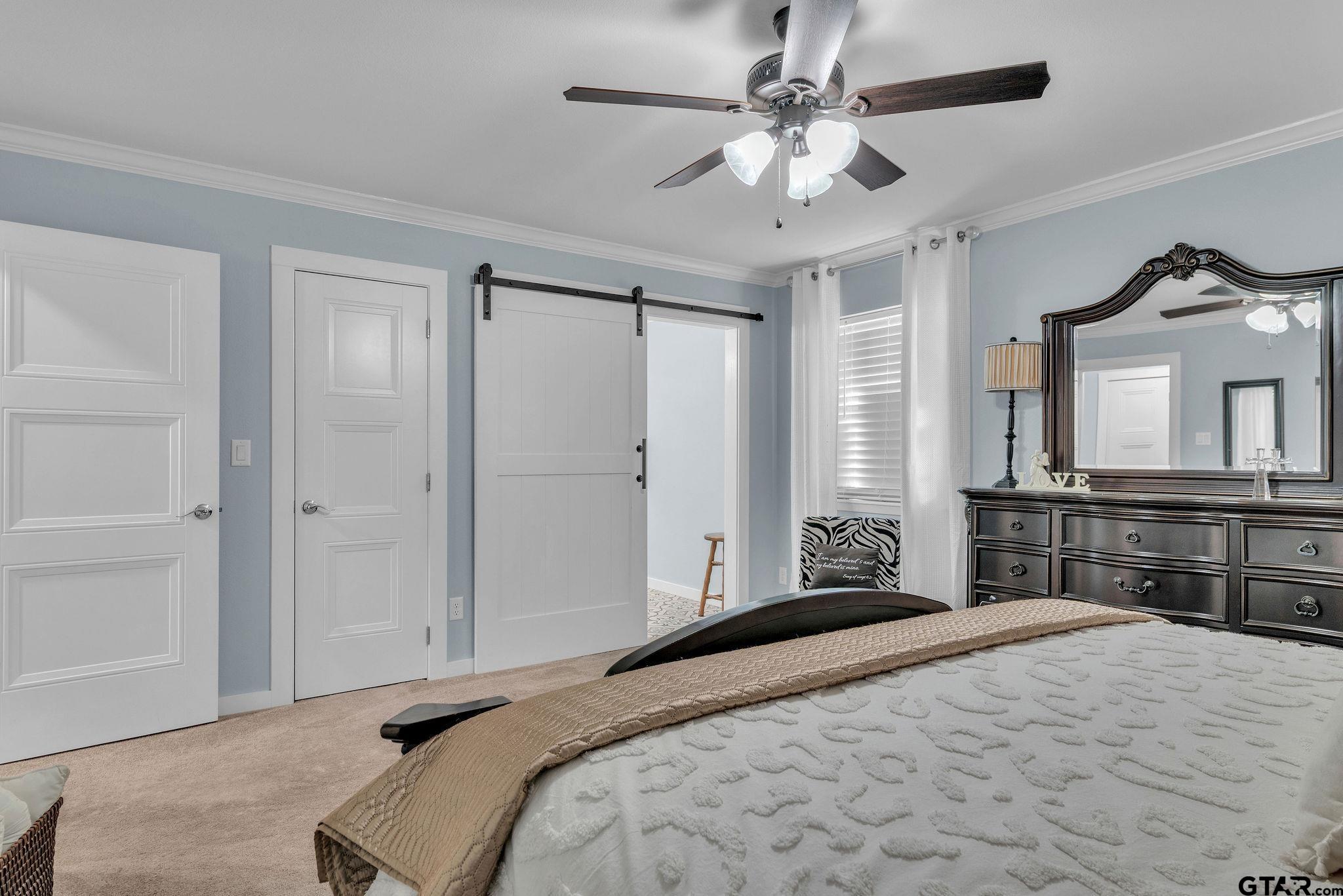 1208 Briarwood Lane Longview, TX 75604 - Photo 19 of 43 a bedroom with a large bed and a dresser