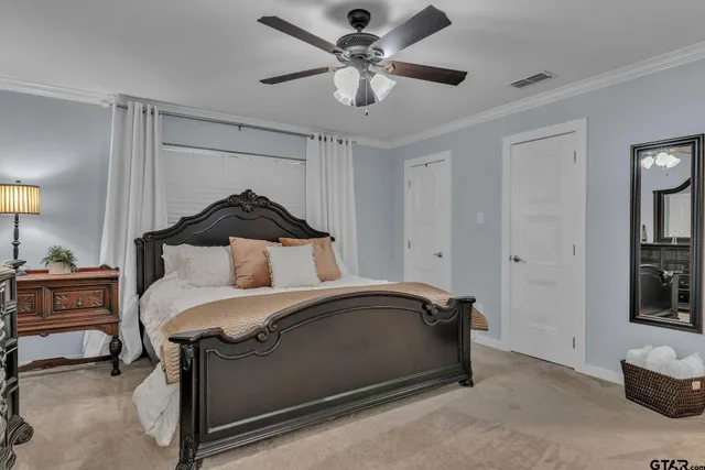 a bedroom with a bed and a ceiling fan