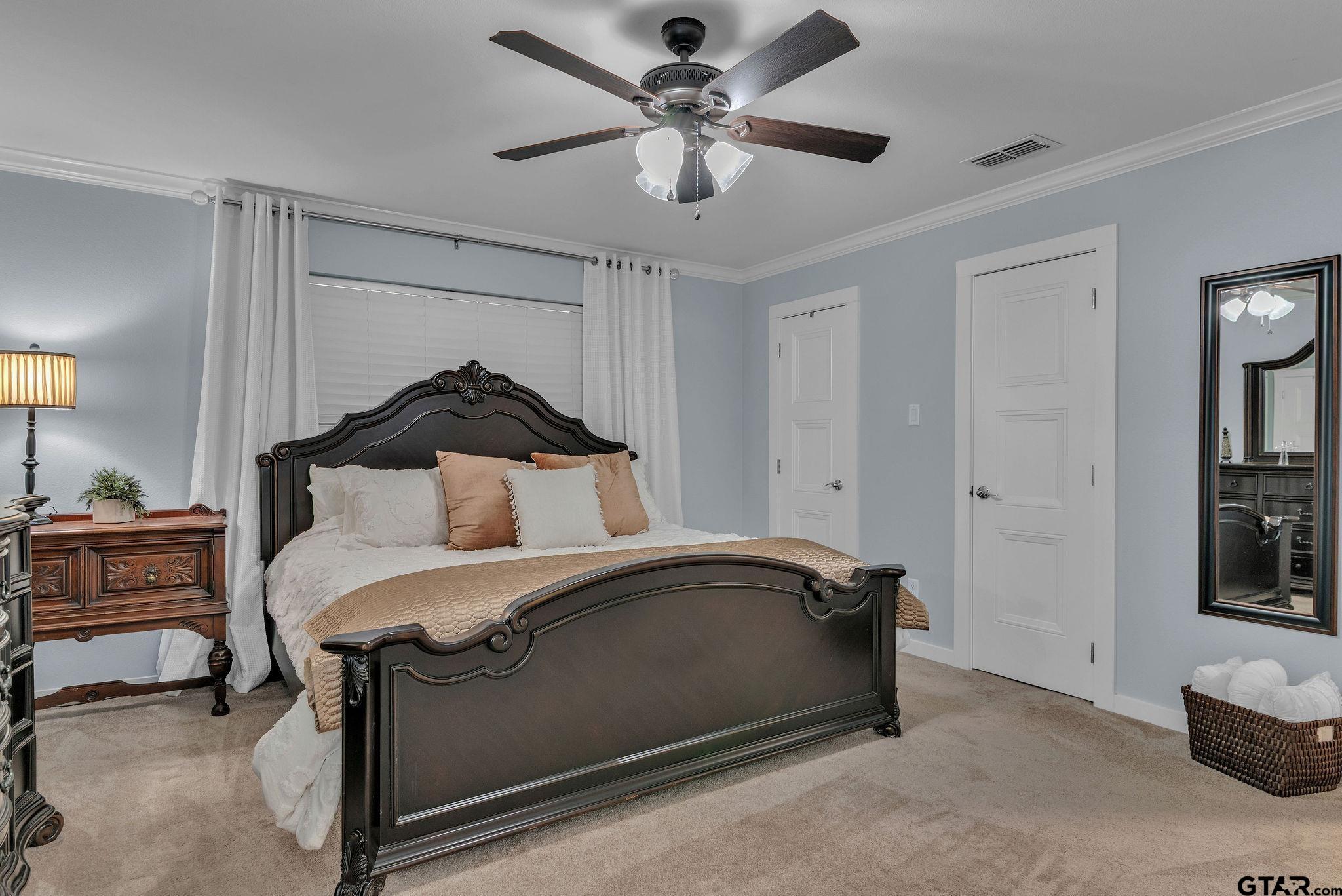 1208 Briarwood Lane Longview, TX 75604 - Photo 21 of 43 a bedroom with a bed and a ceiling fan