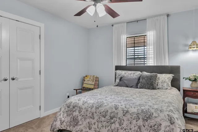 a bedroom with a bed and a window