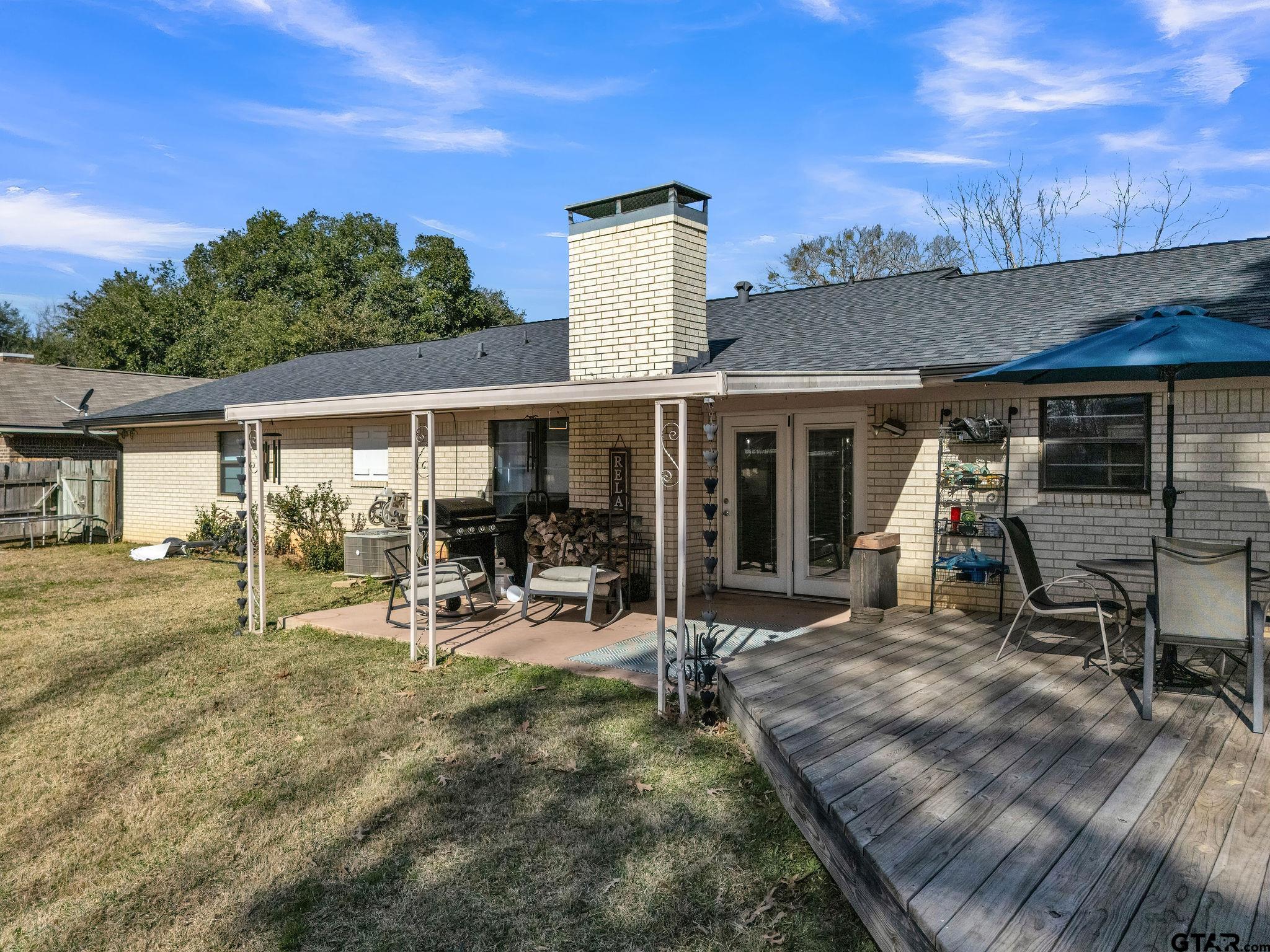 1208 Briarwood Lane Longview, TX 75604 - Photo 31 of 43 a view of a house with backyard outdoor seating area and furniture