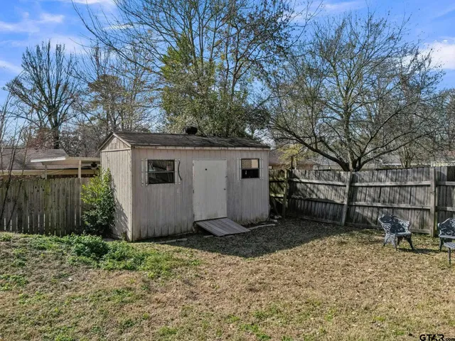 a view of a house with backyard porch and sitting area