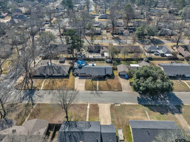 an aerial view of a house with a yard