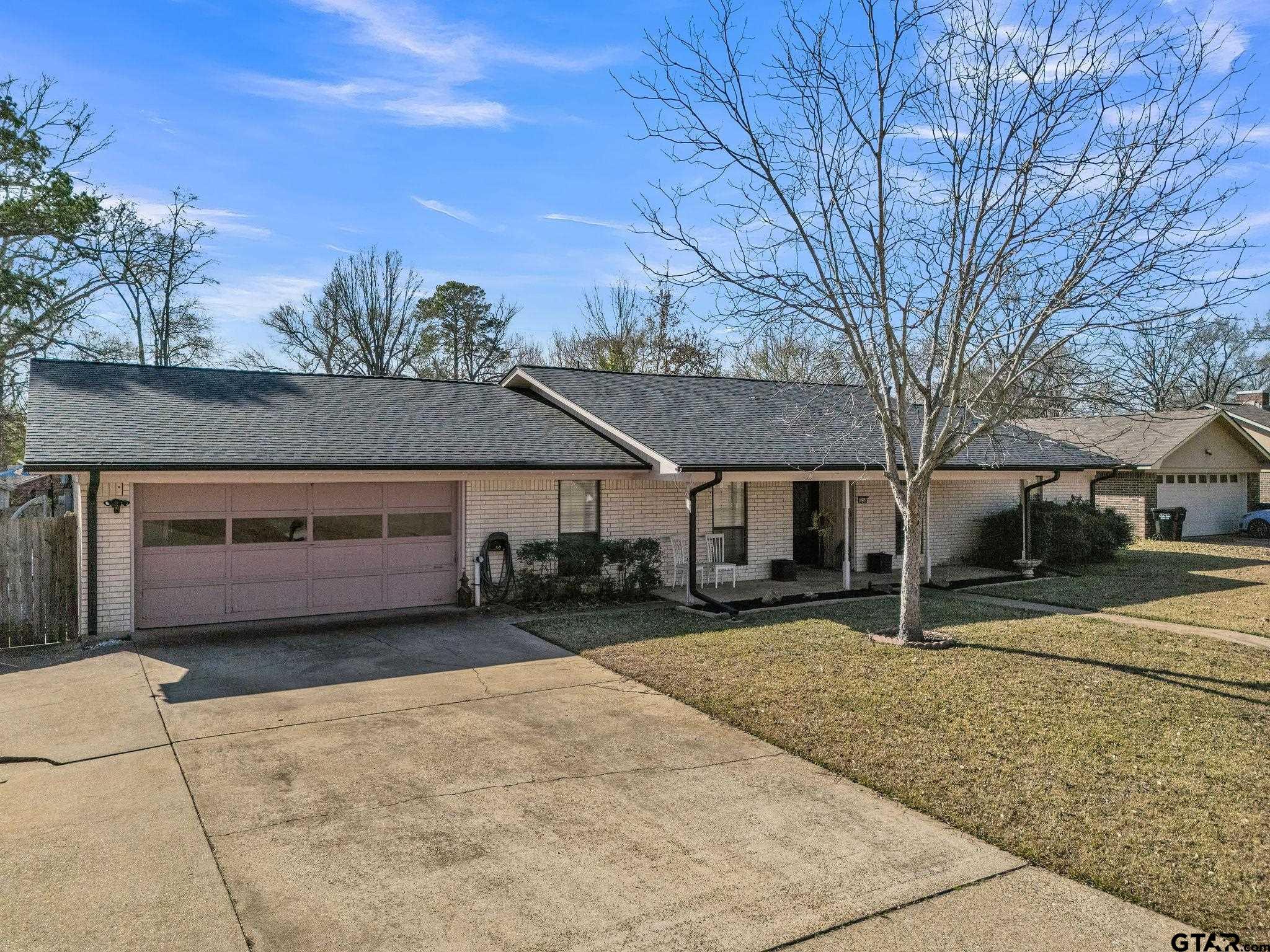 1208 Briarwood Lane Longview, TX 75604 - Photo 42 of 43 a front view of a house with a yard and garage