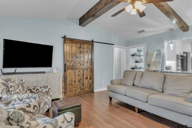 a living room with furniture and a flat screen tv