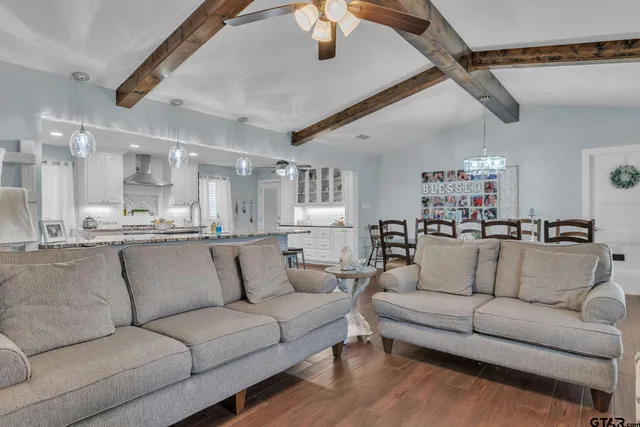 a view of a living room kitchen and a wooden floor