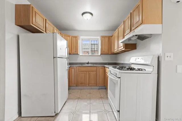 a kitchen with stainless steel appliances a refrigerator and a stove top oven