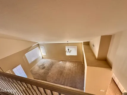 a view of a hallway with stairs