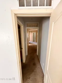 a view of a hallway with a door