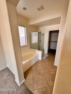 a view of a bathroom with bathtub and shower