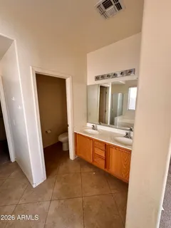 a large white kitchen with a sink a stove and cabinets