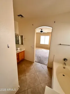 a bathroom with a tub sink and mirror