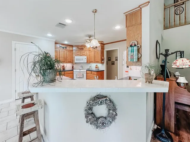 a living room with furniture a chandelier and a flat screen tv