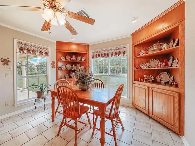 a dining room with furniture and a floor to ceiling window