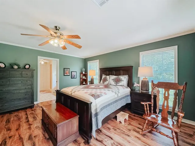a bedroom with a bed and wooden floor