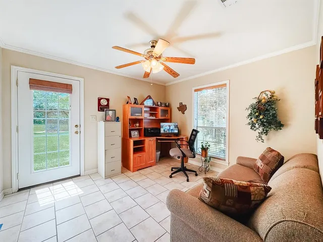 a living room with furniture a chandelier and a window