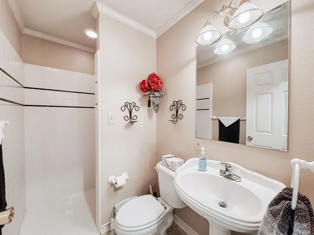 a bathroom with a sink mirror and toilet
