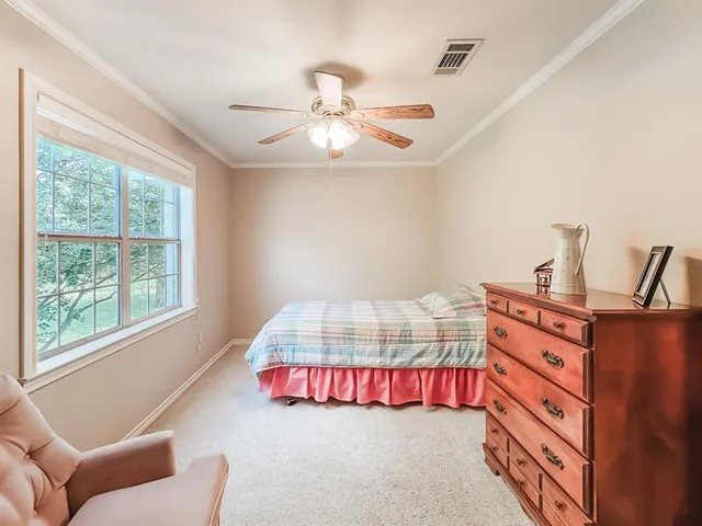 a bedroom with bed and a window