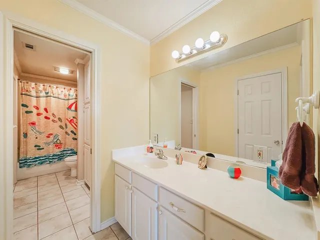 a bathroom with a sink vanity and mirror