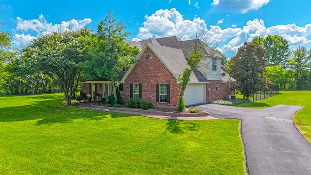 a front view of a house with swimming pool having outdoor seating