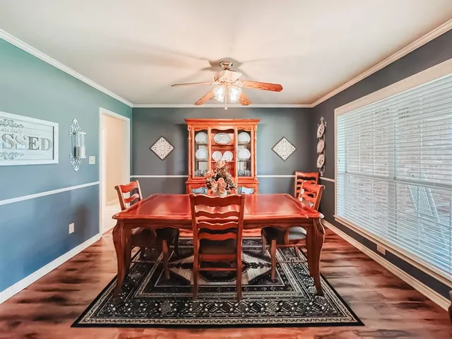 a dining room with furniture a rug and wooden floor