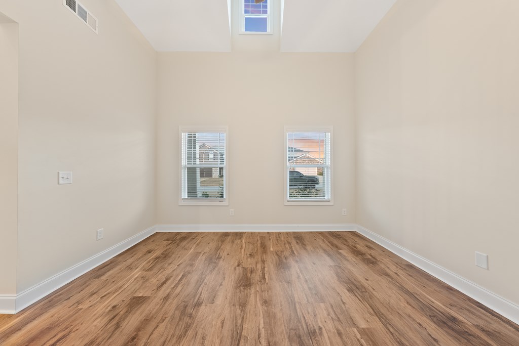 7312 Pine Chase Drive Midland, GA 31820 - Photo 19 of 51 an empty room with wooden floor and windows