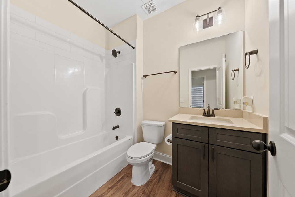 7312 Pine Chase Drive Midland, GA 31820 - Photo 21 of 51 a bathroom with a sink toilet a shower and a mirror
