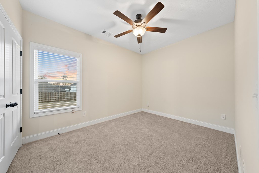 7312 Pine Chase Drive Midland, GA 31820 - Photo 22 of 51 an empty room with a window and a ceiling fan