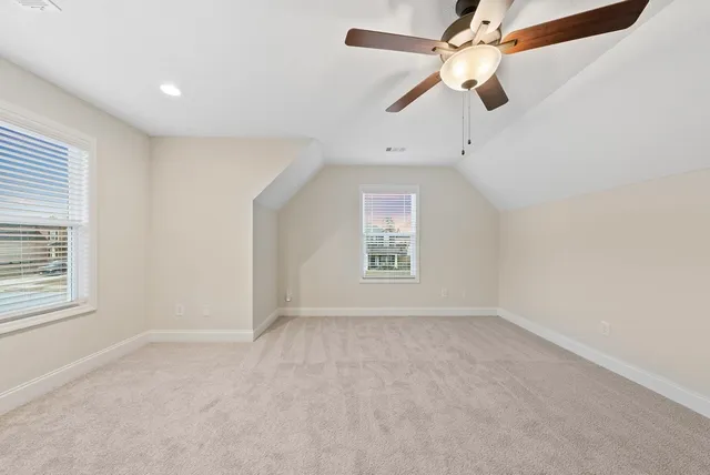 a spacious bathroom with a tub a sink and a mirror