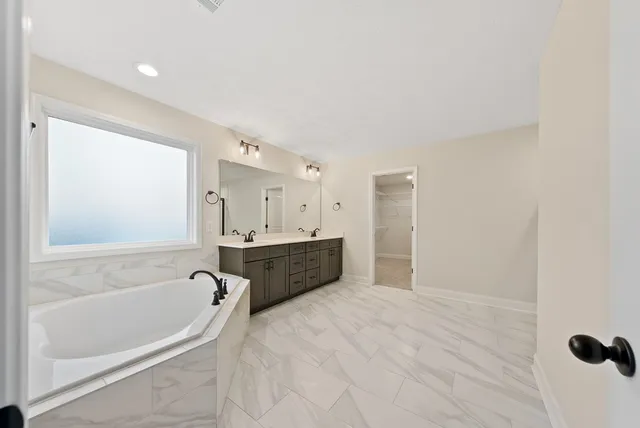 a white bath tub sitting in a bathroom