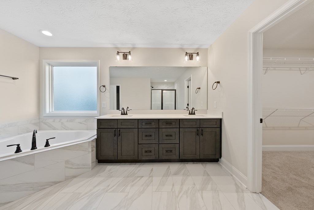7312 Pine Chase Drive Midland, GA 31820 - Photo 29 of 51 a spacious bathroom with a tub sink double vanity and mirror