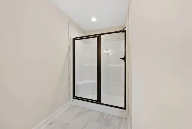 a bathroom with a double vanity sink toilet mirror and bathtub