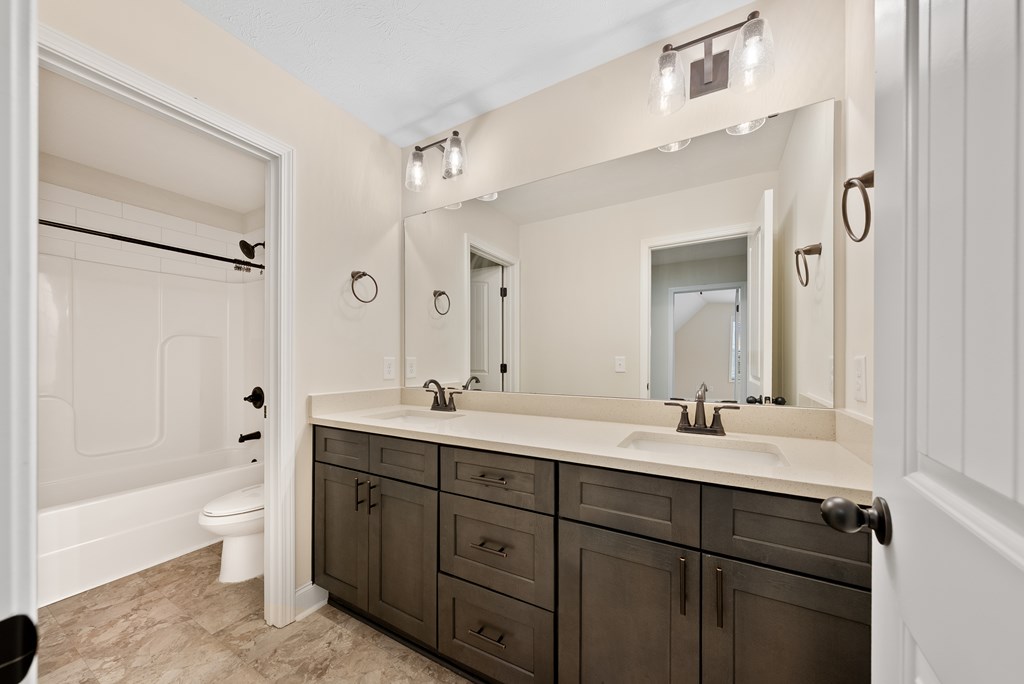 7312 Pine Chase Drive Midland, GA 31820 - Photo 32 of 51 a bathroom with a double vanity sink toilet mirror and bathtub