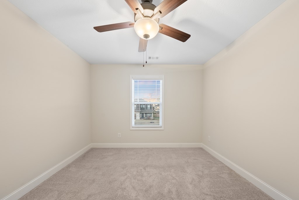 7312 Pine Chase Drive Midland, GA 31820 - Photo 38 of 51 an empty room with a window and a fan
