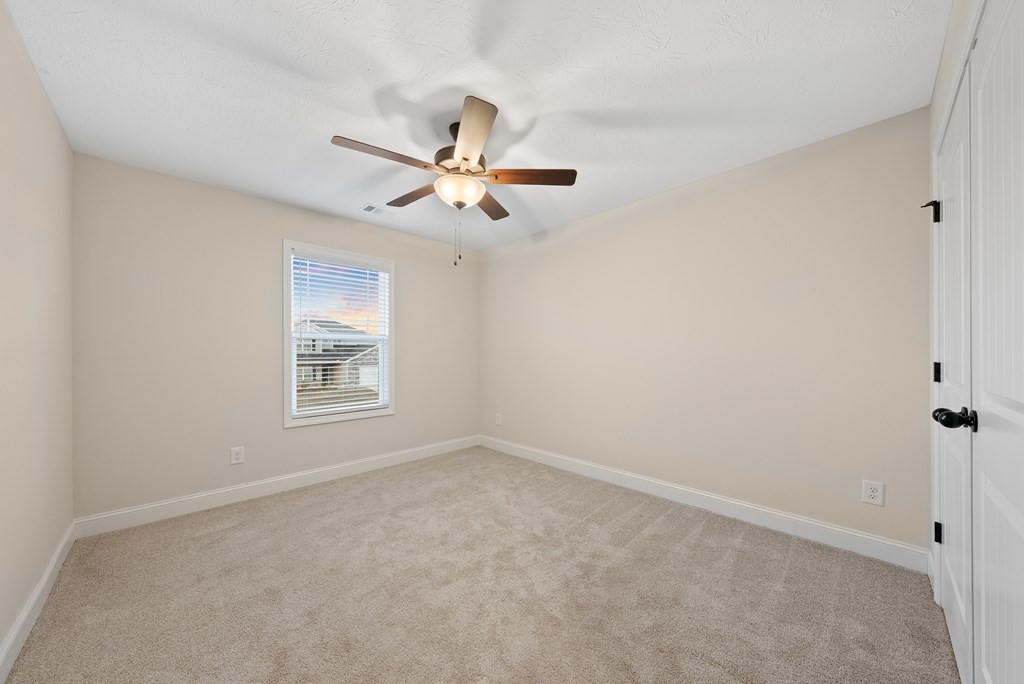 7312 Pine Chase Drive Midland, GA 31820 - Photo 39 of 51 a view of a room with a ceiling fan and a window