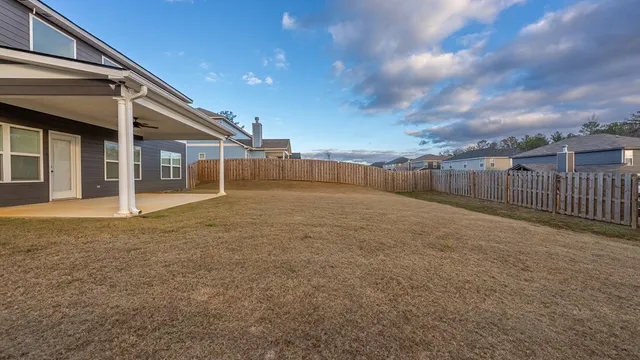 a view of a house with a backyard