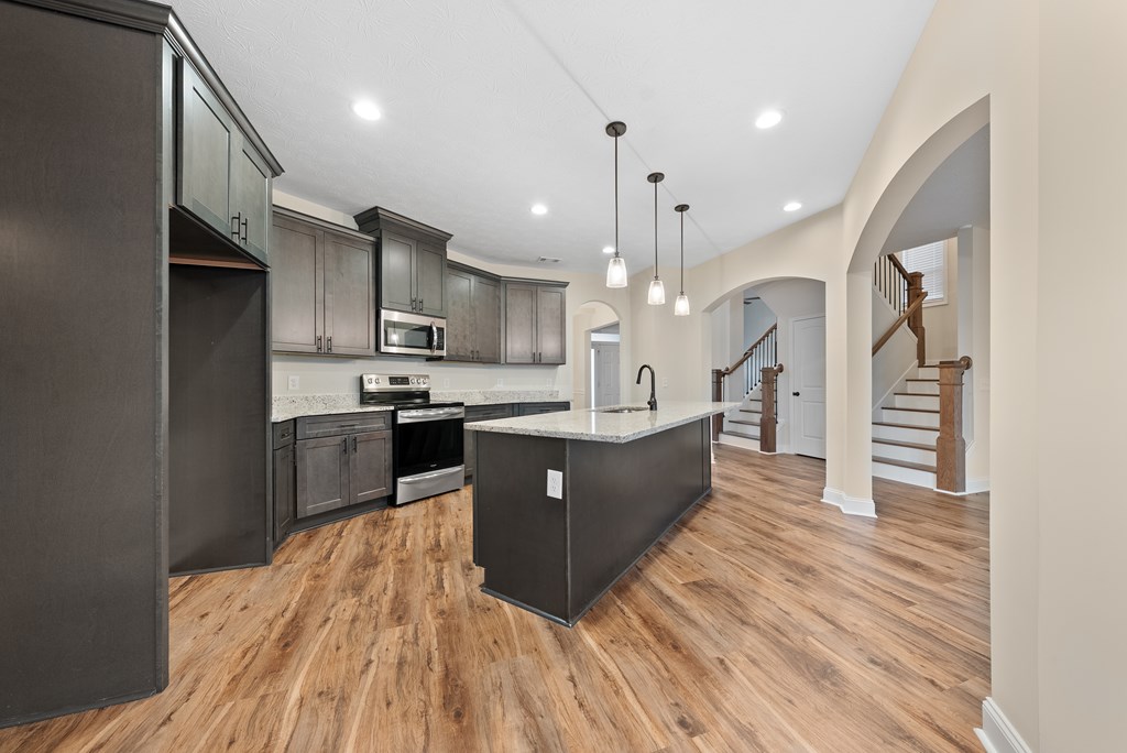 7312 Pine Chase Drive Midland, GA 31820 - Photo 8 of 51 a large kitchen with stainless steel appliances kitchen island granite countertop a large counter top and wooden floors