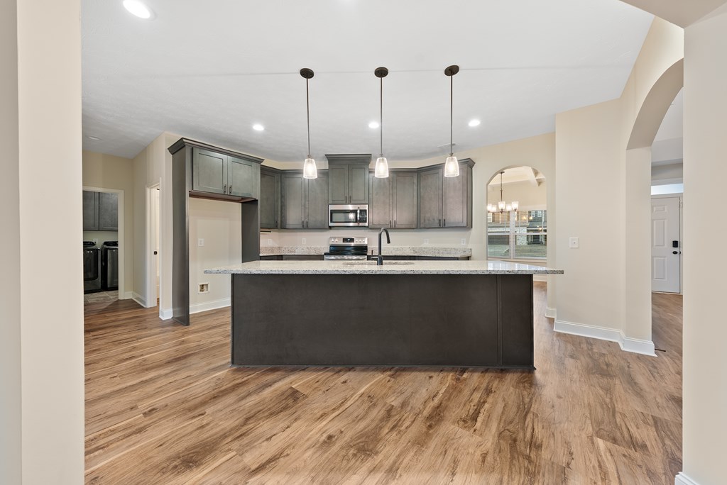 7312 Pine Chase Drive Midland, GA 31820 - Photo 9 of 51 a kitchen with kitchen island stainless steel appliances a sink refrigerator and microwave
