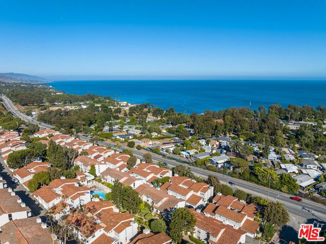 an aerial view of residential building and ocean