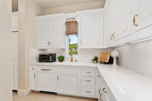 a utility room with dryer washer and a sink