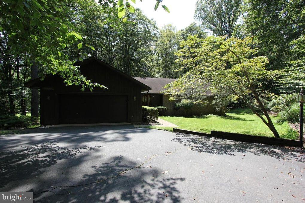 10264 Greystone Road Manassas, VA 20111 - Photo 15 of 23 a backyard of a house with a yard and garage