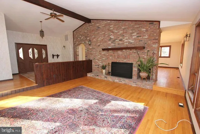 a view of a livingroom with a fireplace and window