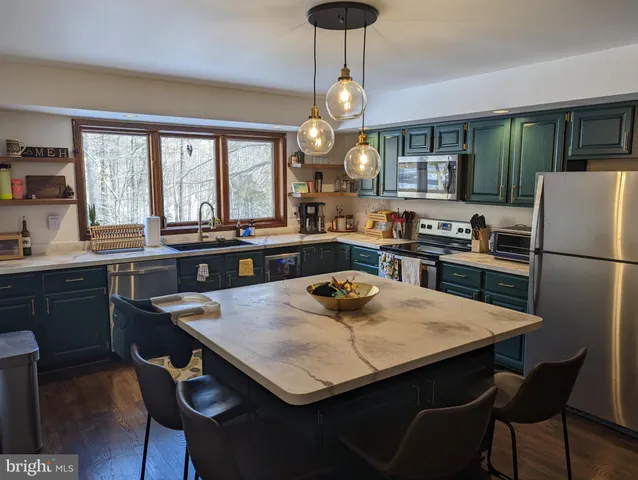 a kitchen with a table chairs refrigerator and cabinets