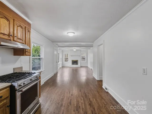 a view of kitchen and hall with wooden floor