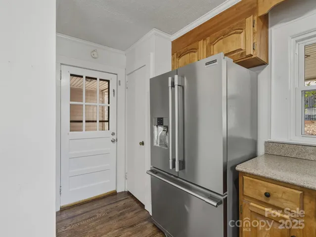 a metallic refrigerator freezer sitting inside of a kitchen