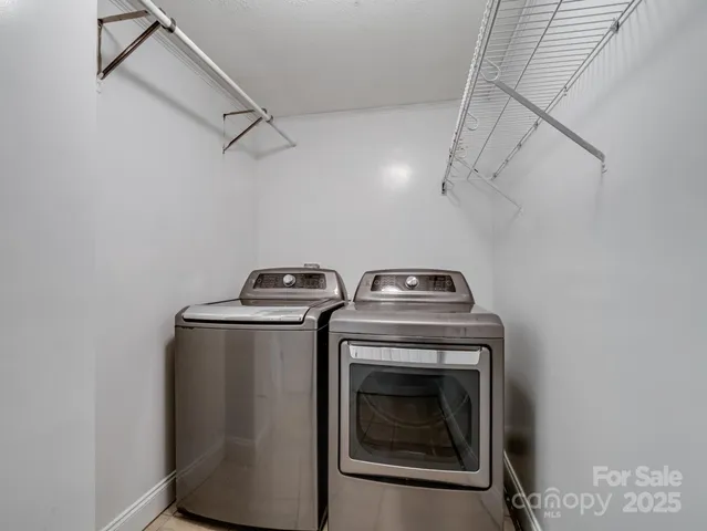 a view of storage and utility room with washer and dryer