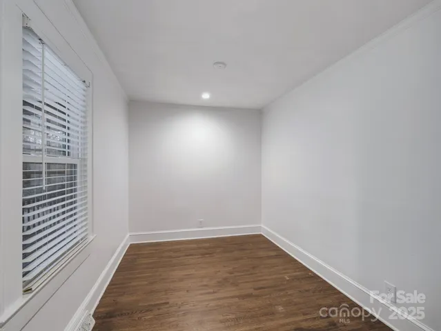 a view of a room with wooden floor and fence