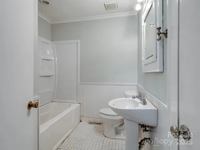 a bathroom with a sink a toilet and bathtub