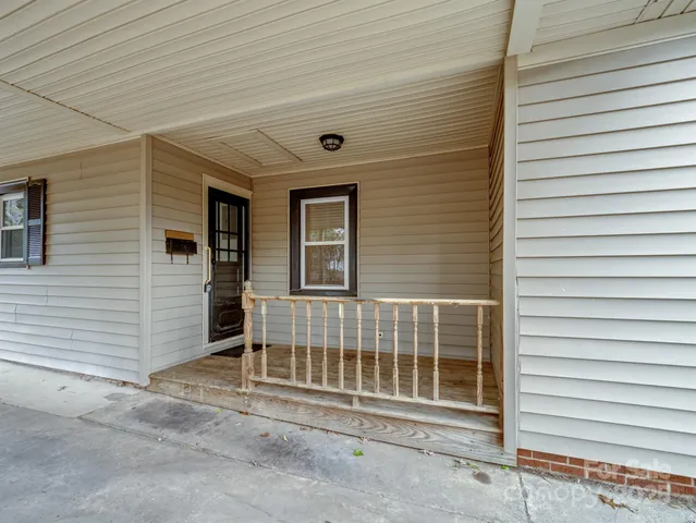 a view of a house with a door and wooden walls